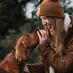 Farblich abgestimmter Irish Setter und Frau genießen die Zweisamkeit im Harz am Oderteich